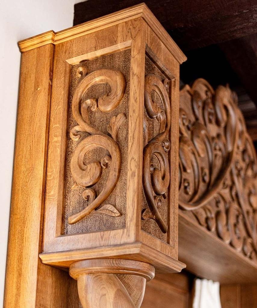 Hand-carved wooden corbel bracket supporting a ceiling beam